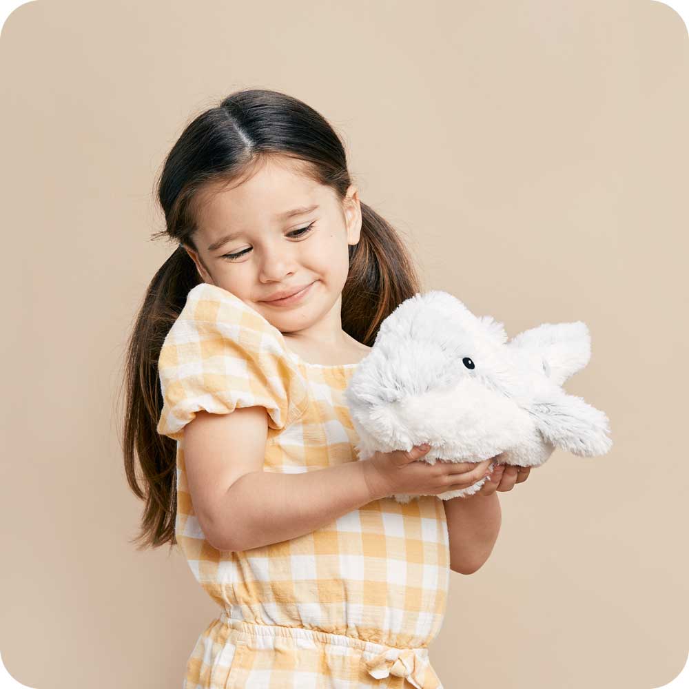 Image 101: Little girl golding Cute Weighted Lavender Scented Dolphin Stuffed Animal Heating Pad Warmies