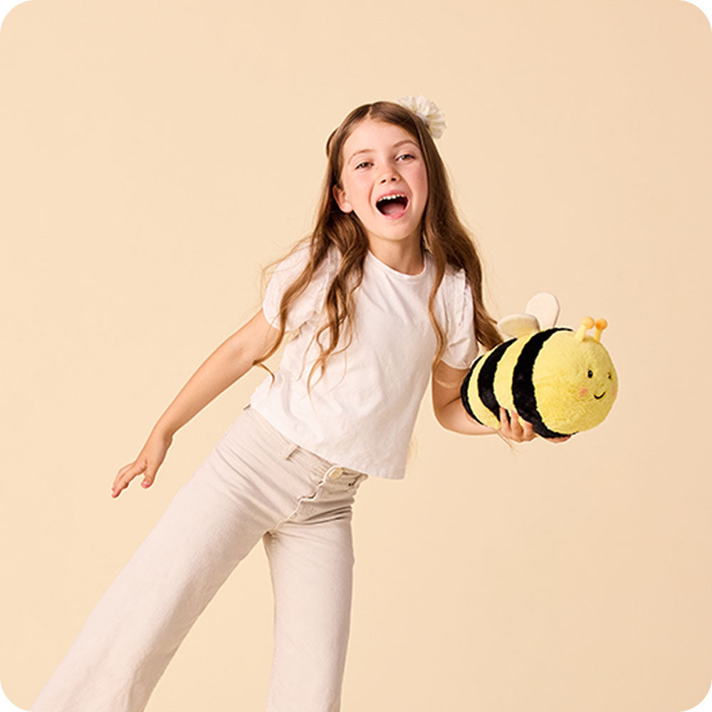 Image 104: girl holding bee stuffed animal