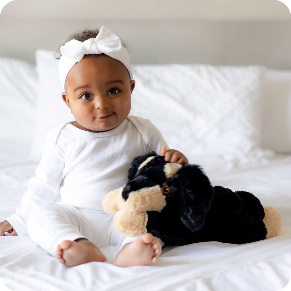 Image 101: Baby girl holding Soft Warm Weighted Dachshund Plush Warmies