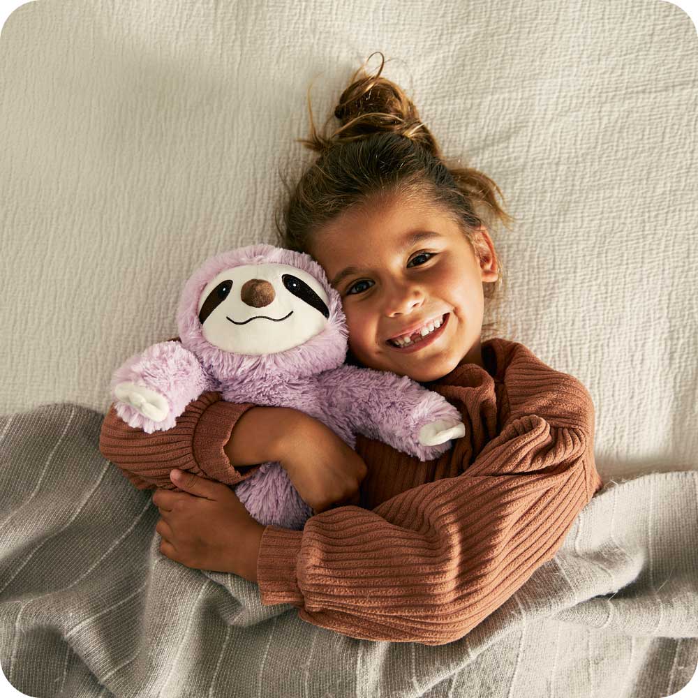 Image 103: Child laying down with Cute Weighted Lavender Scented Purple Sloth Stuffed Animal Heating Pad Warmies