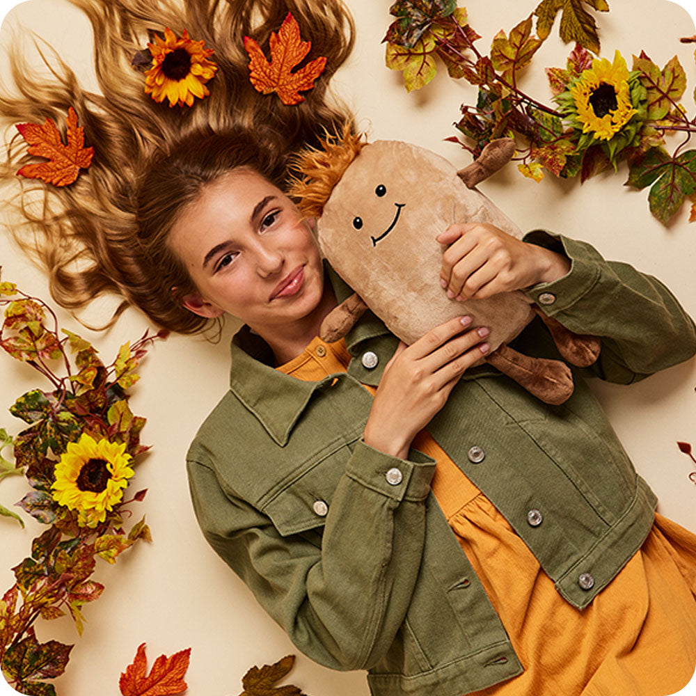 Image 99: girl holding potato stuffed animal warmies