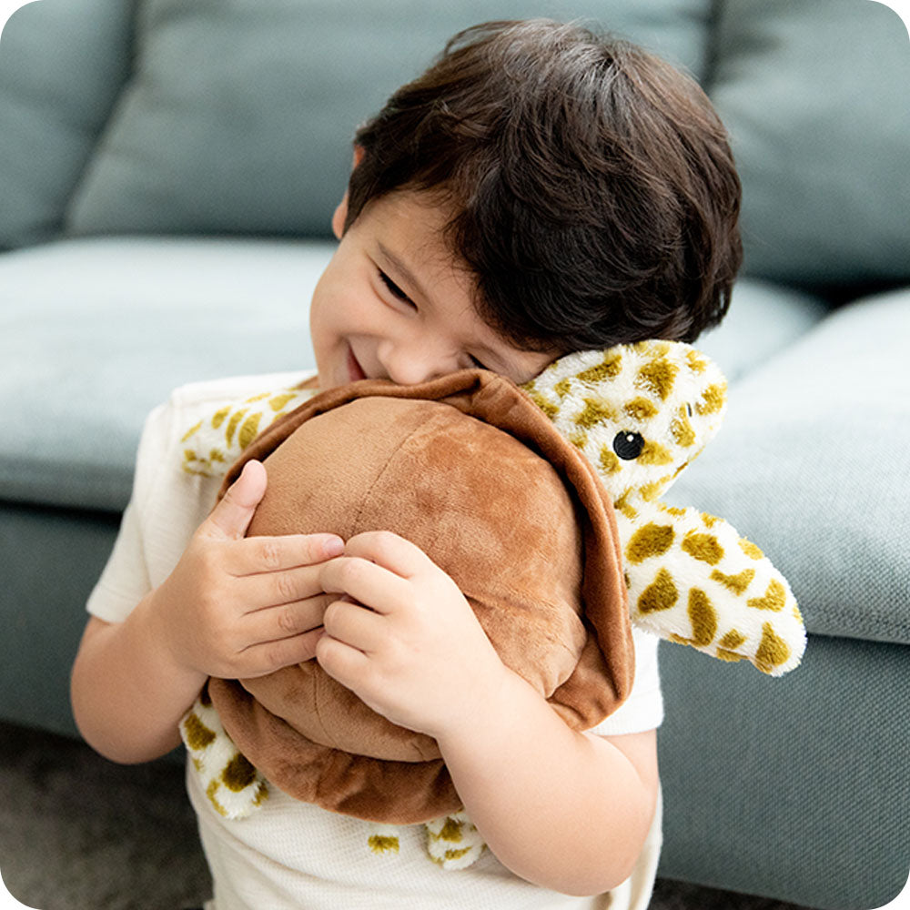 Image 104: boy hugging sea turtle stuffed animal warmies