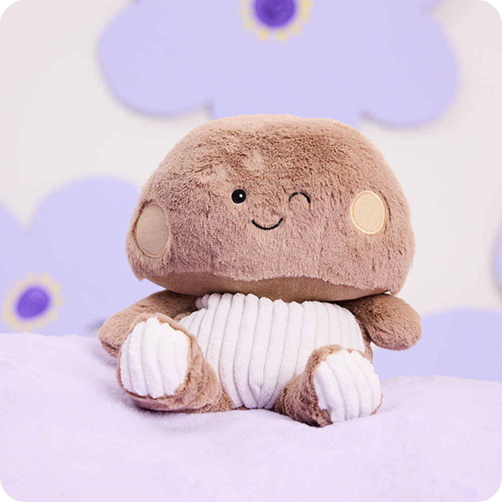Image 108: brown mushroom stuffed animal on purple background