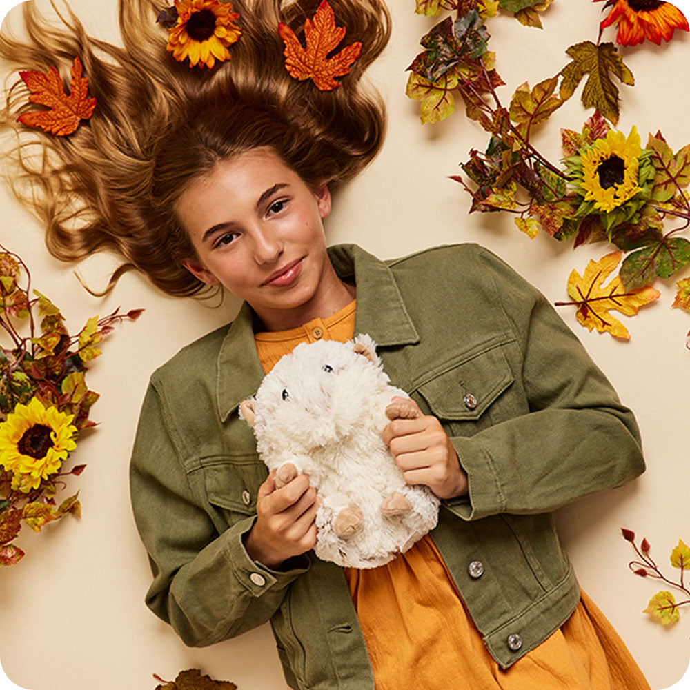 Image 101: autumn decorations around teen holding hamster stuffed animal