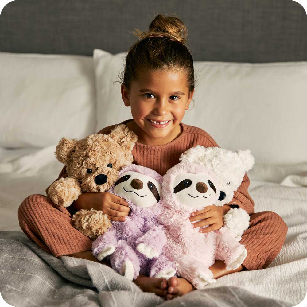 Image 103: Little girl holding many Cute Weighted Lavender Scented Pink Sloth Stuffed Animal Heating Pad Warmies