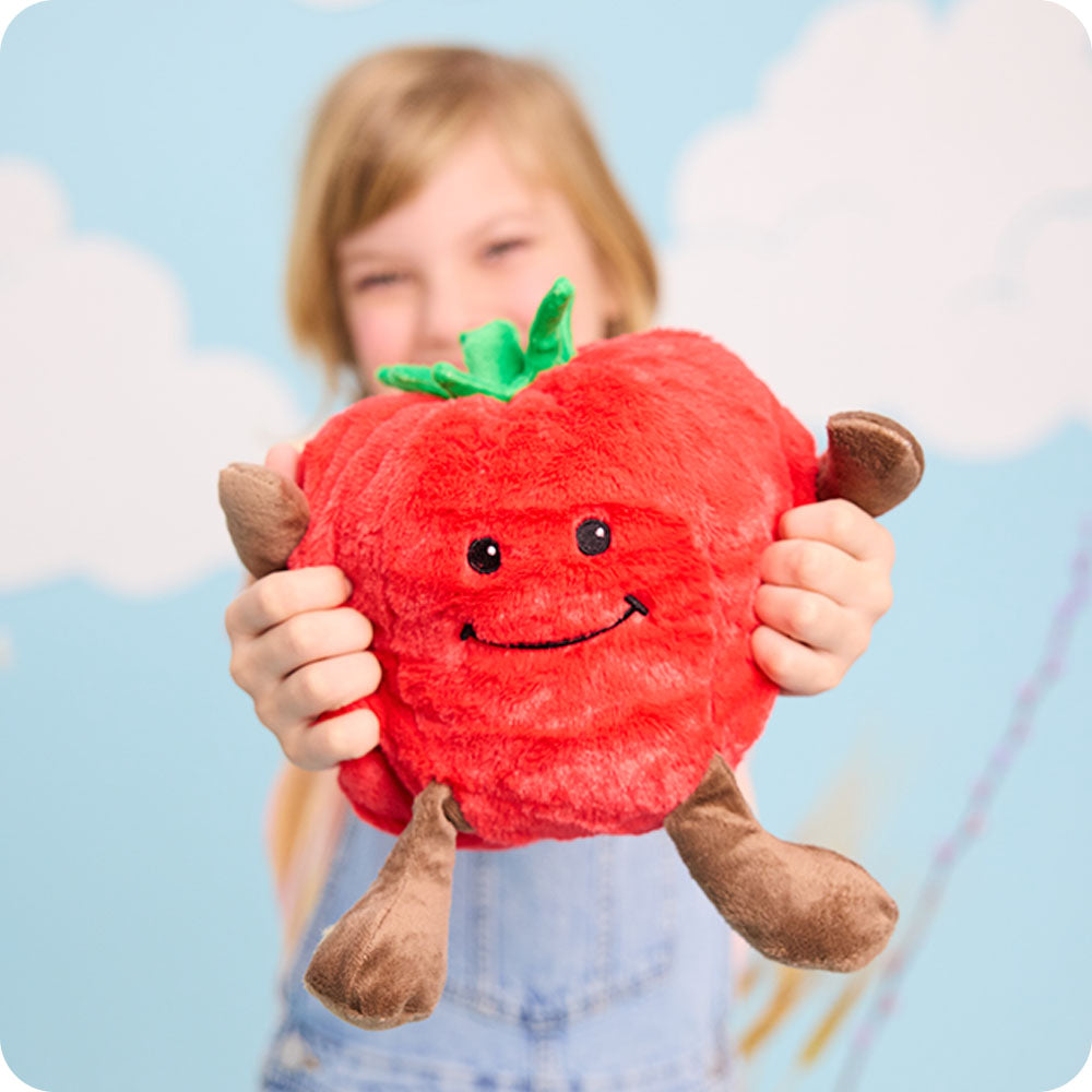 Image 99: girl holding tomato stuffed animal warmies