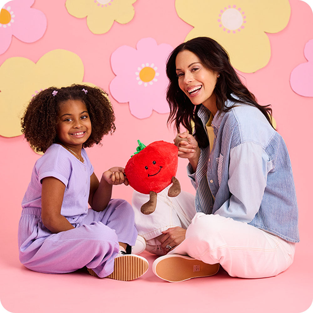 Image 100: mom and daughter holding tomato stuffed animal