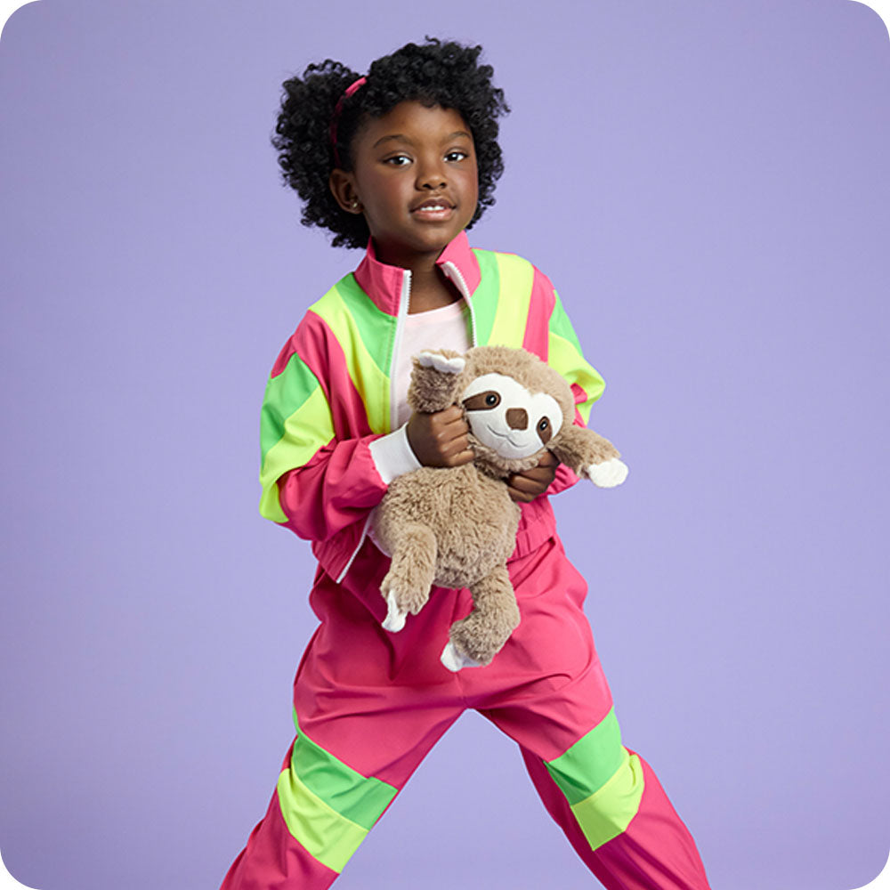 Image 99: girl holding sloth stuffed animal with purple background