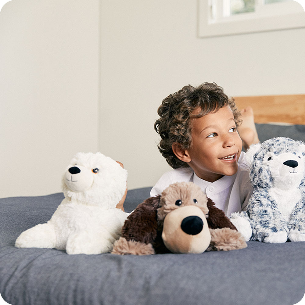 Image 98: baby seal stuffed animal on boys bed