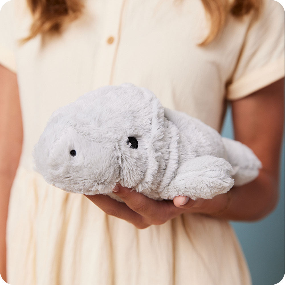 Image 102: girl holding manatee stuffed animal