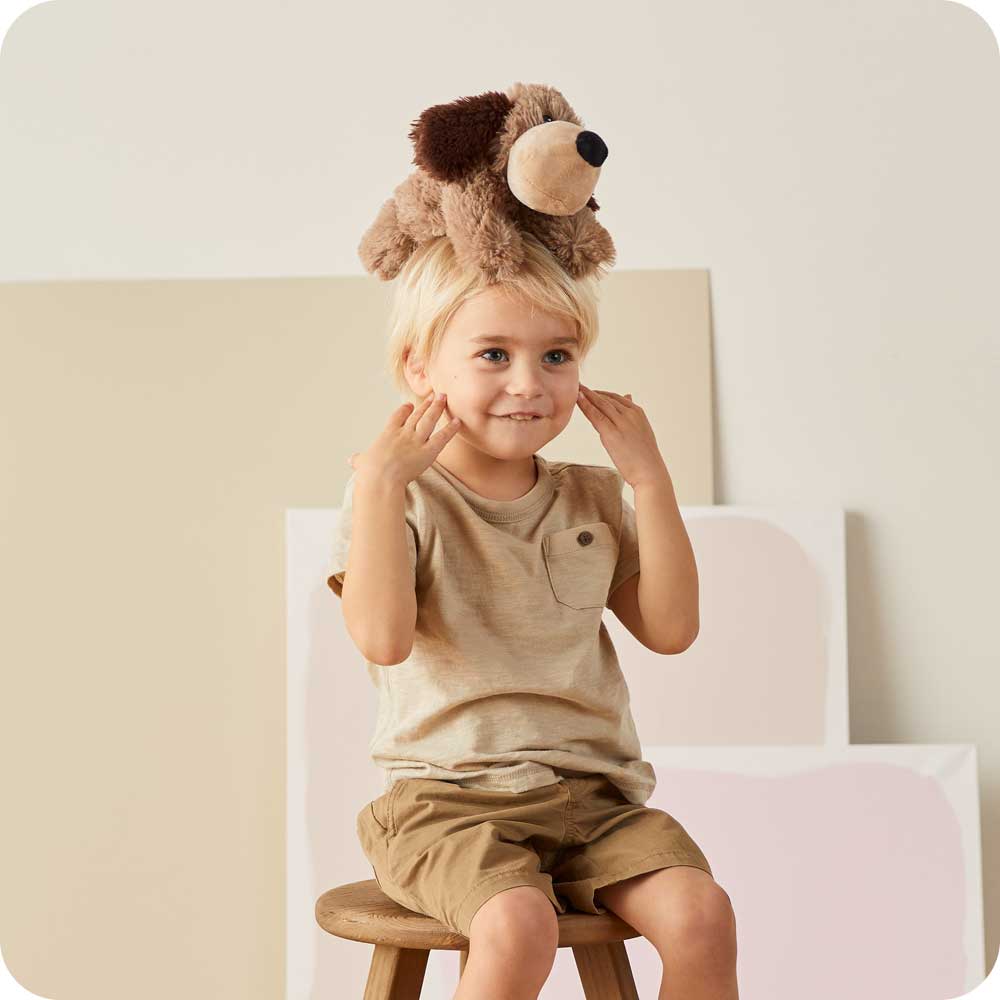 Image 102: Little boy sitting with Soft Warm Weighted Brown Dog Plush Warmies