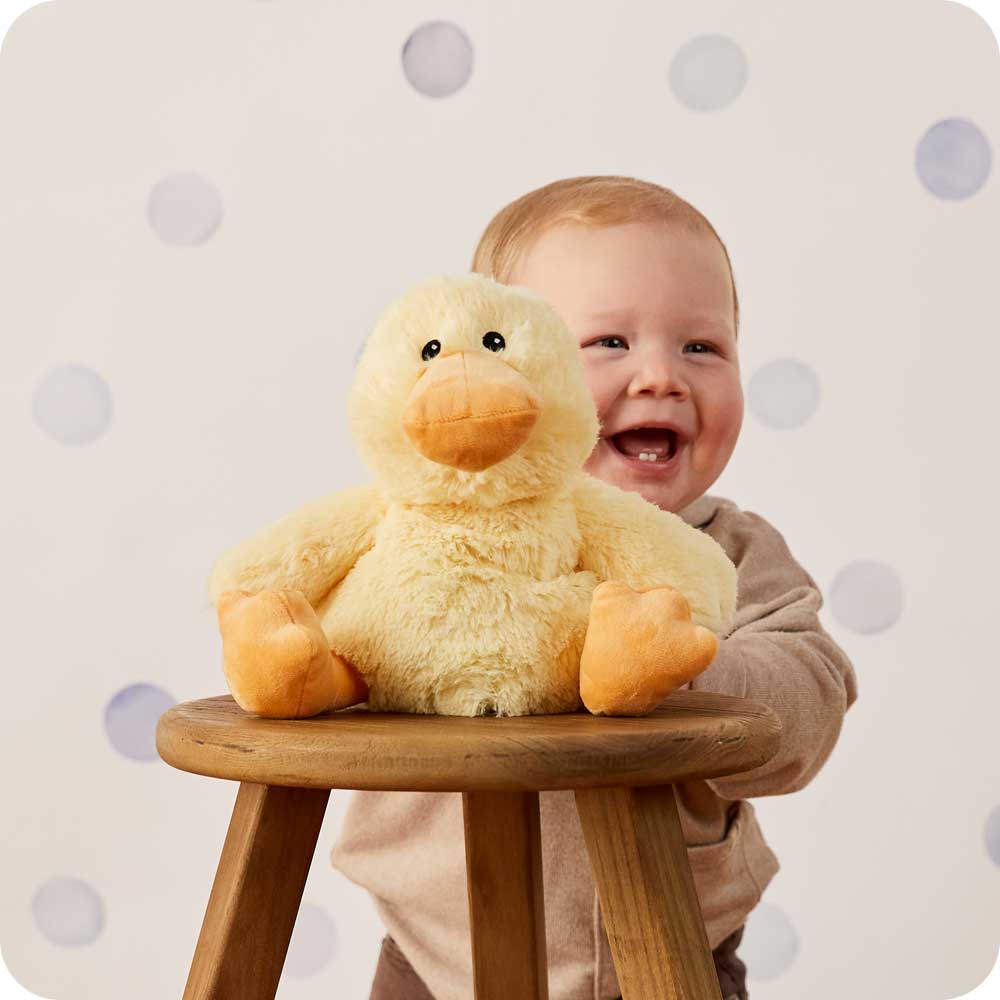 Image 100: Baby boy holding Cute Weighted Lavender Scented Duck Stuffed Animal Heating Pad Warmies