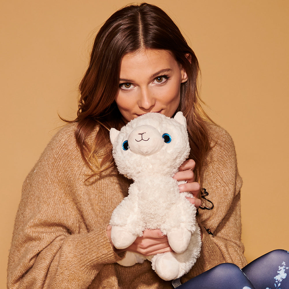 Image 99: Woman holding Cute Weighted Lavender Scented Llama Stuffed Animal Heating Pad Warmies