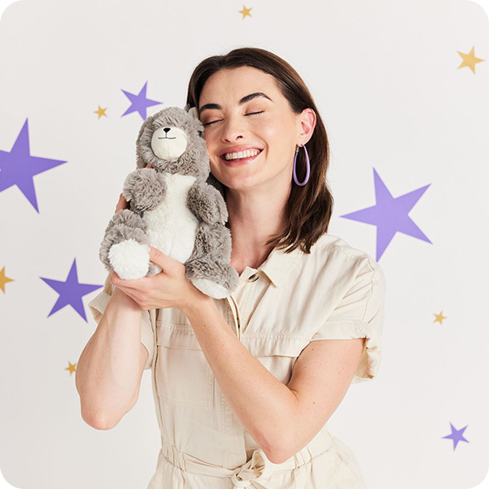 Image 102: woman cuddling squirrel stuffed animal warmies