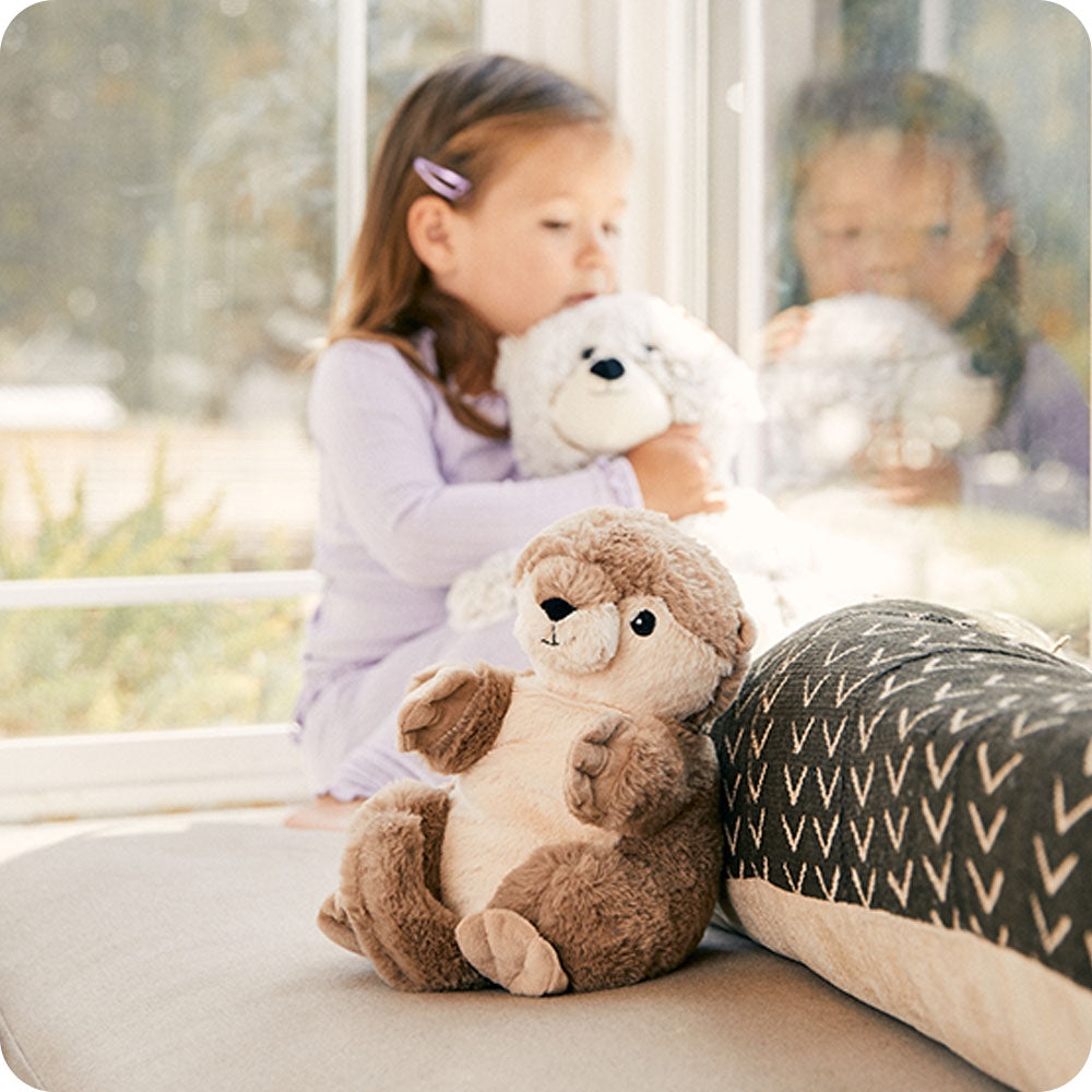 Image 104: otter stuffed animal sitting on couch