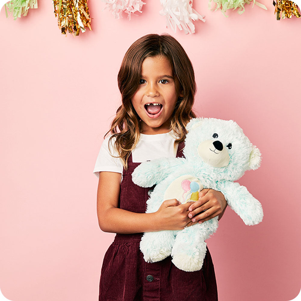 Image 102: party setting lifestyle little girl holding celebration bear stuffed animal