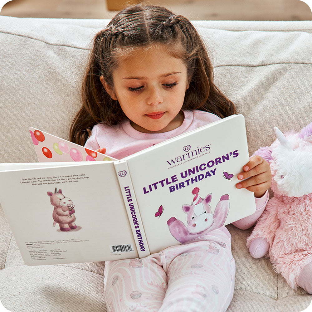 Image 90: toddler reading warmies Little Unicorn's Birthday book