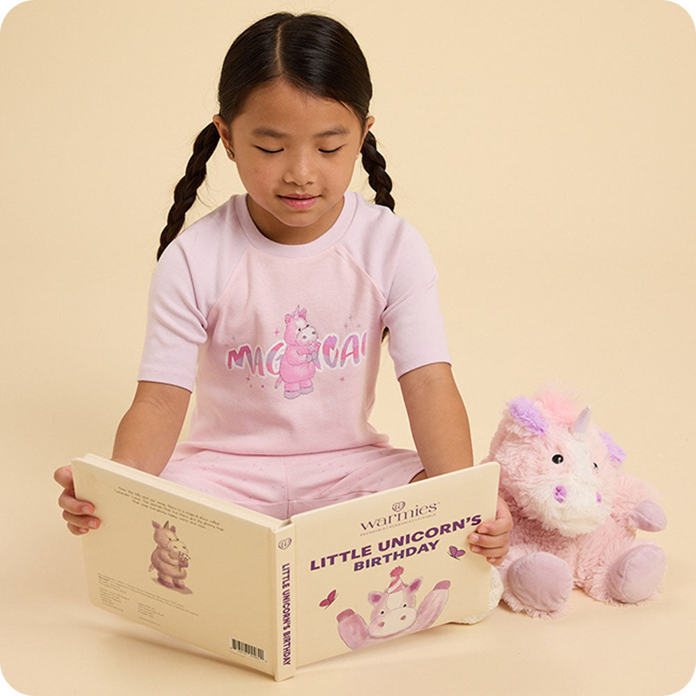 Image 91: Girl reading Little Unicorn's Birthday warmies book