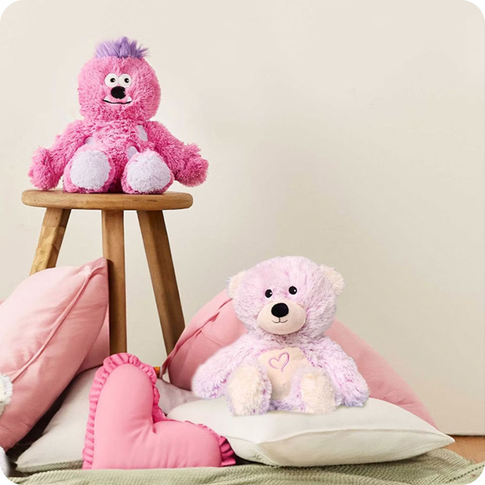 Image 98: pink bear stuffed animal on pillow pile