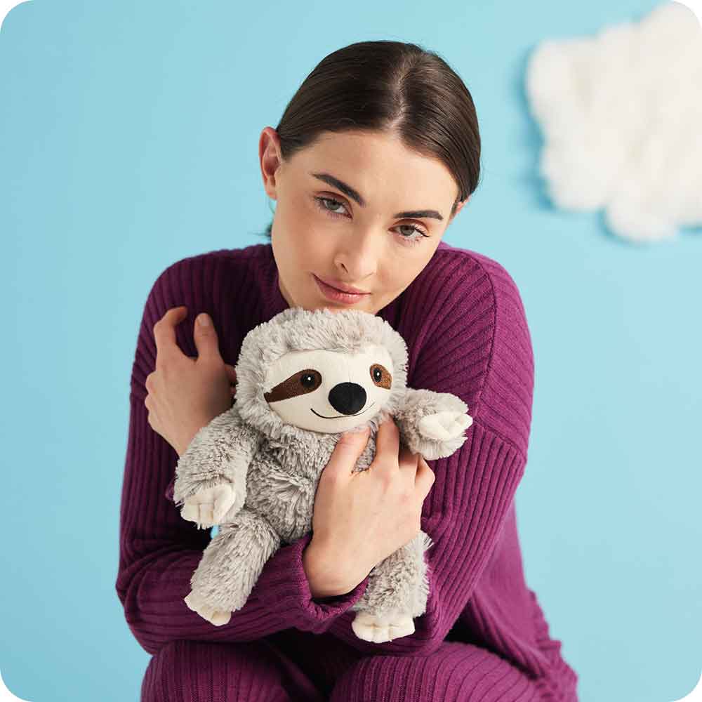 Image 100: Girl hugging Cute Weighted Lavender Scented Gray Sloth Stuffed Animal Heating Pad Warmies