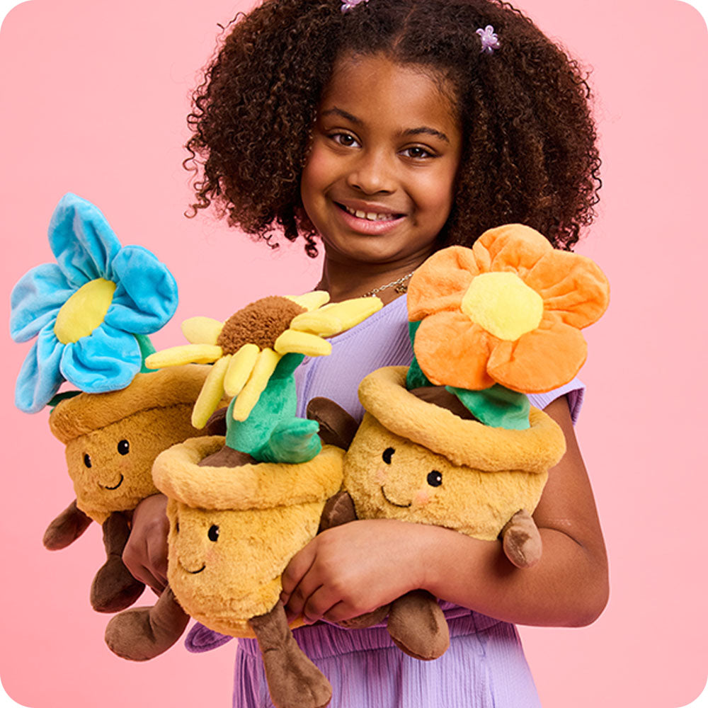 Image 102: girl holding three flower pot stuffed animal warmies