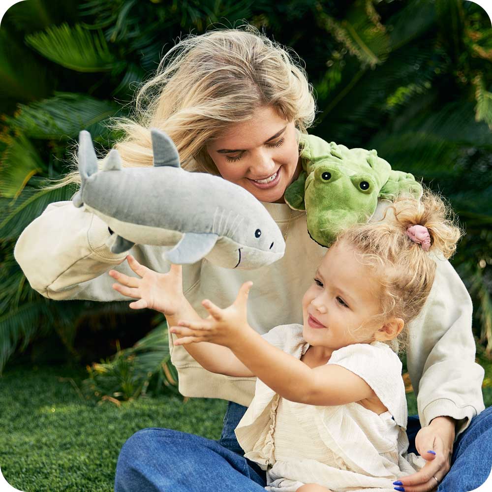 Image 101: Mom and daughter playing with Cute Weighted Lavender Scented Shark Stuffed Animal Heating Pad Warmies