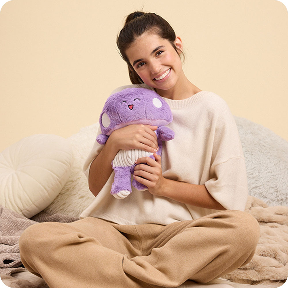 Image 110: girl holding purple mushroom stuffed animal warmies