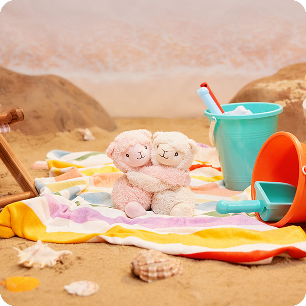 Image 103: llama hugs stuffed animal warmies at the beach