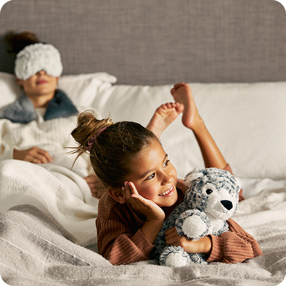 Image 100: mother and daughter cozy with snow leopard stuffed animal