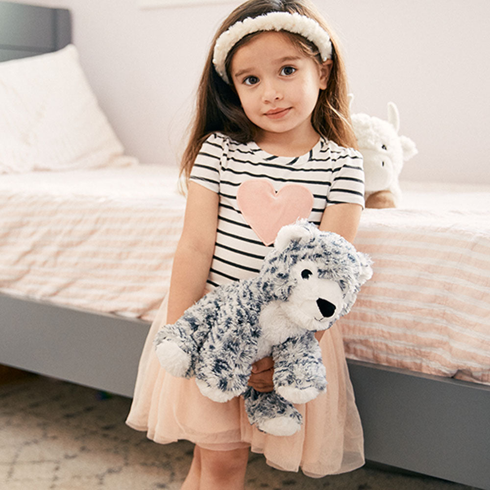 Image 101: girl holding snow leopard stuffed animals