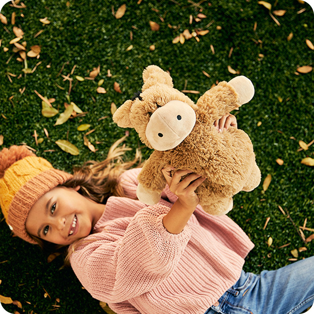 Image 101: autumn lifestyle girl holding donkey stuffed animals