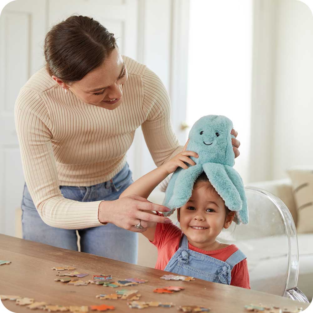 Image 101: Mom and son playing with Cute Weighted Lavender Scented Octopus Stuffed Animal Heating Pad Warmies