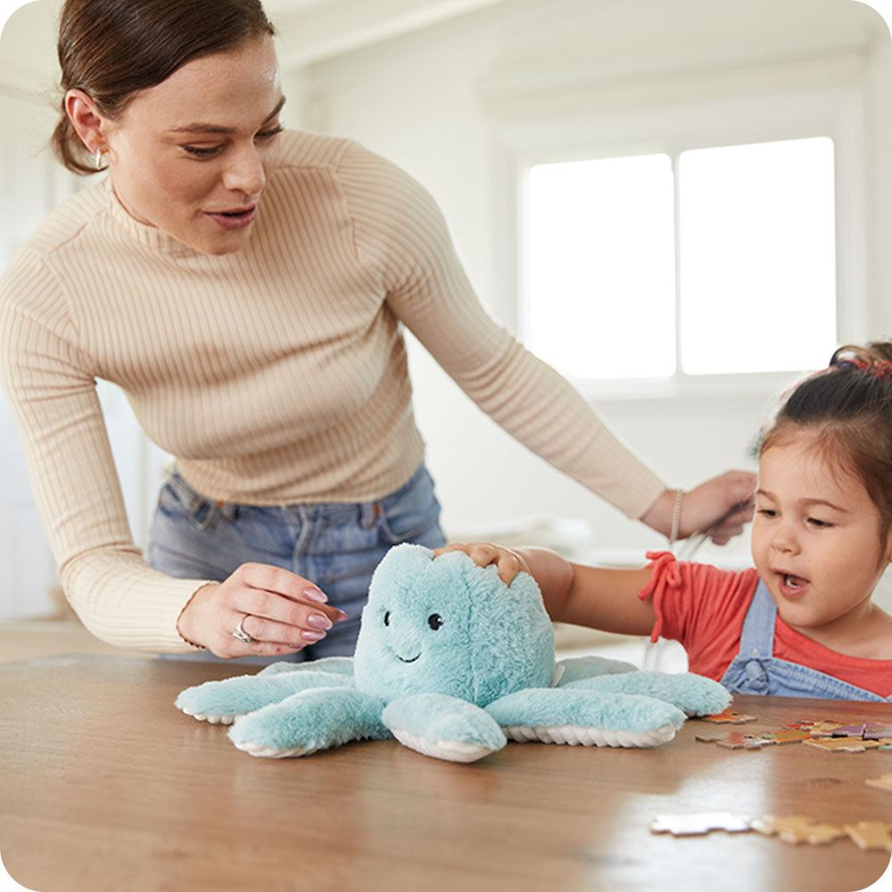 Image 102: mom and daughter playing with octopus stuffed animal