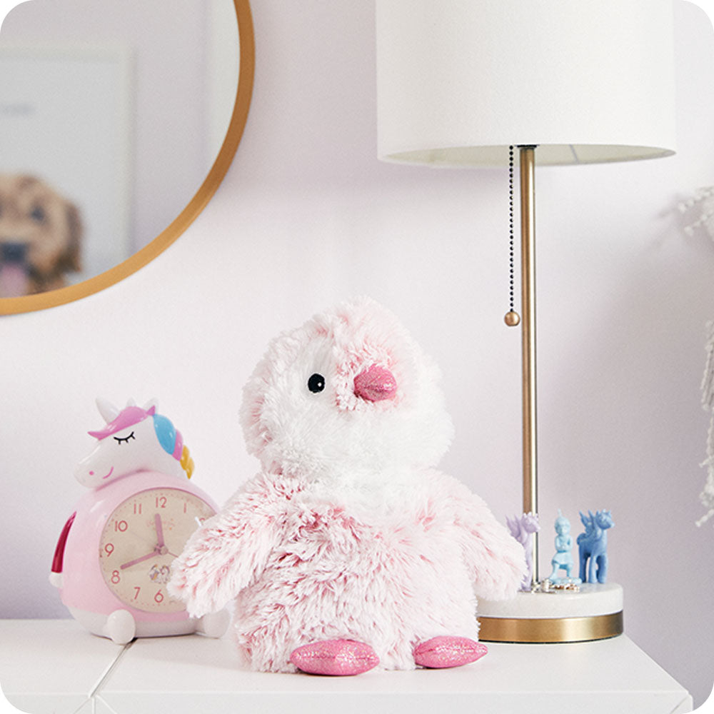 Image 101: pink penguin stuffed animal on kids dresser