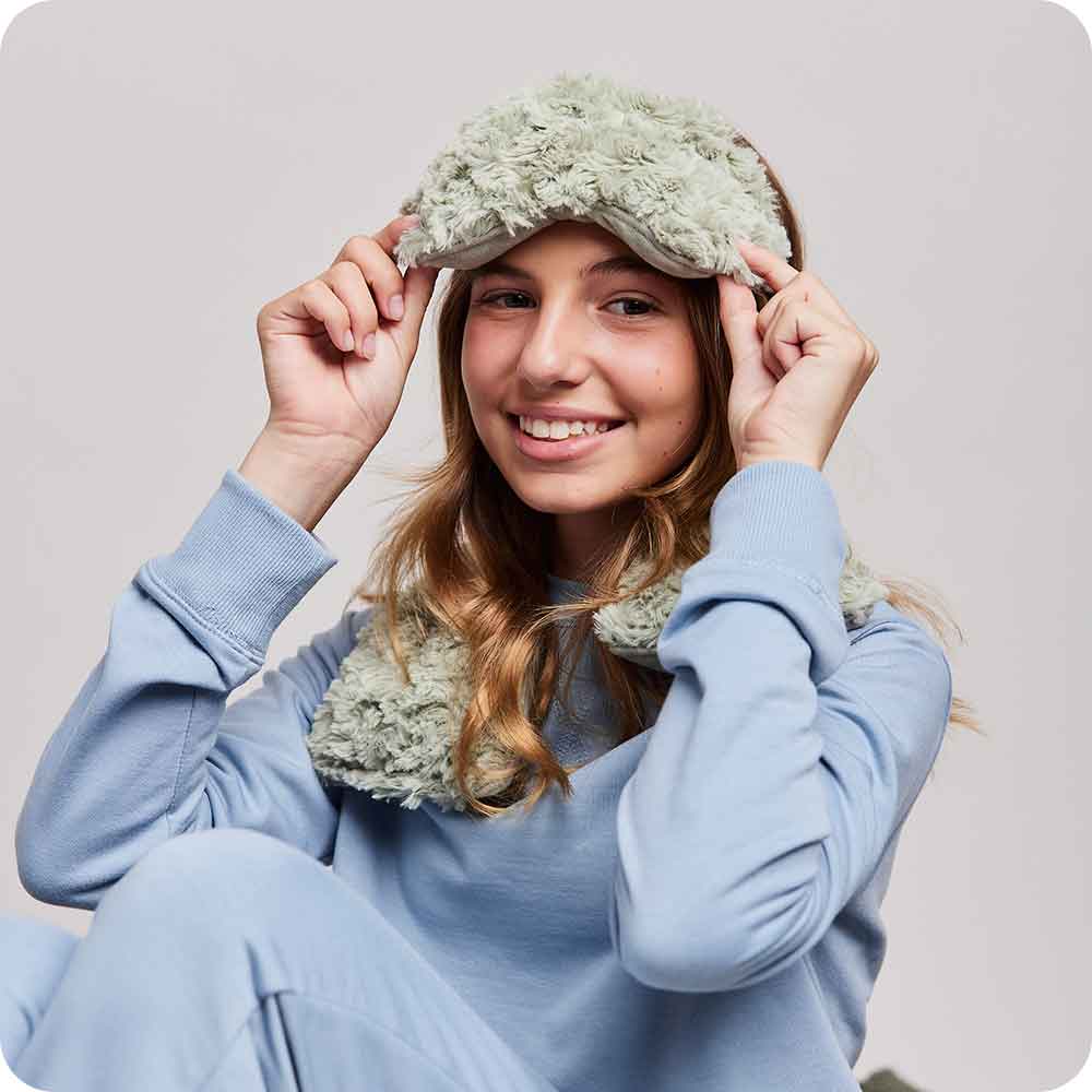 Image 91: Teen wearing Microwavable Curly Sage Green Warmies Eye Mask - Warmies USA