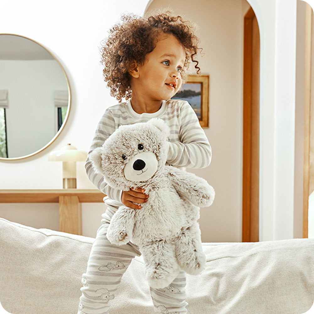 Image 99: child holding marshmallow brown bear warmies lifestyle
