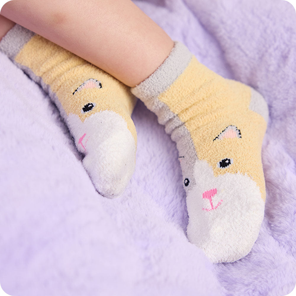 Image 114: detail of warmies calico cat socks on purple background