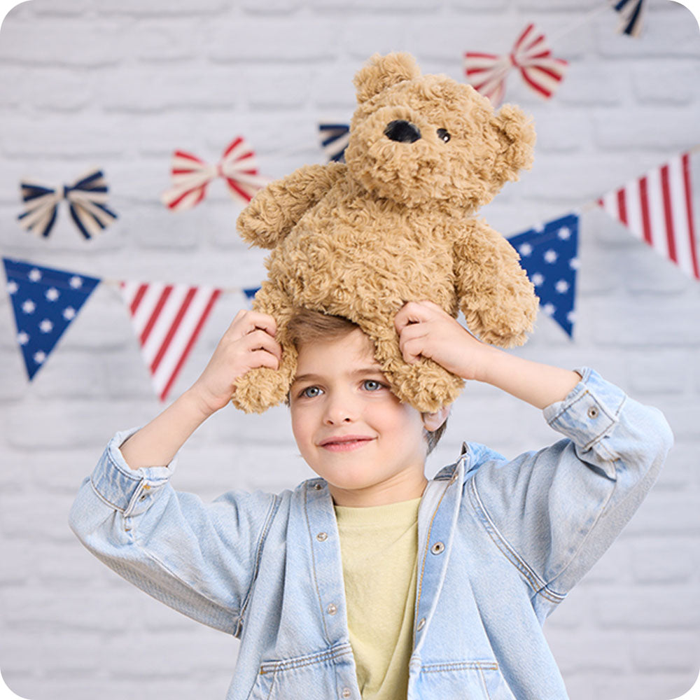 Image 104: brown curly bear lifestyle stuffed animal on boys head