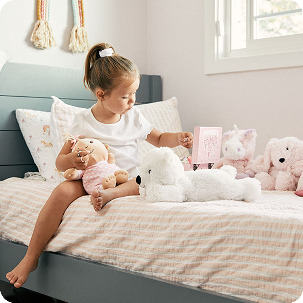 Image 101: white bear warmies on bed lifestyle
