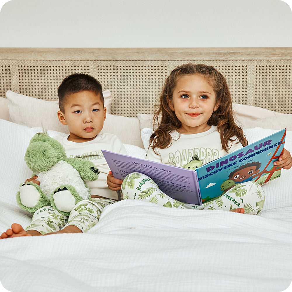 Image 98: boy and girl reading Warmies Dinosaur Discovers Confidence book