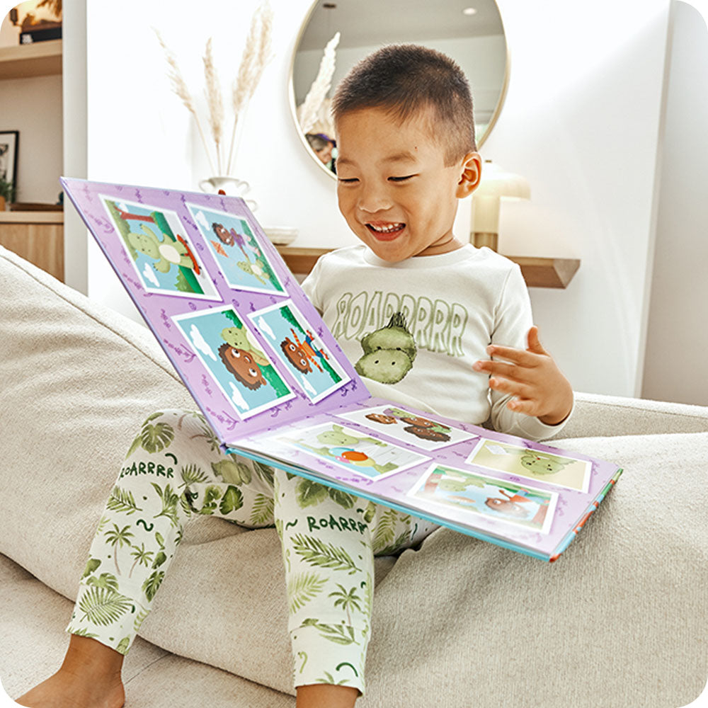 Image 99: boy laughing and reading warmies Dinosaur Discovers Confidence book