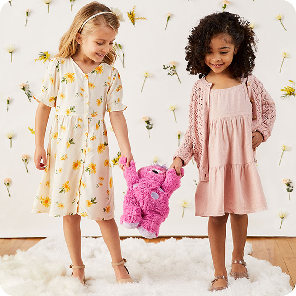 Image 105: two girls holding cute pink monster stuffed animal