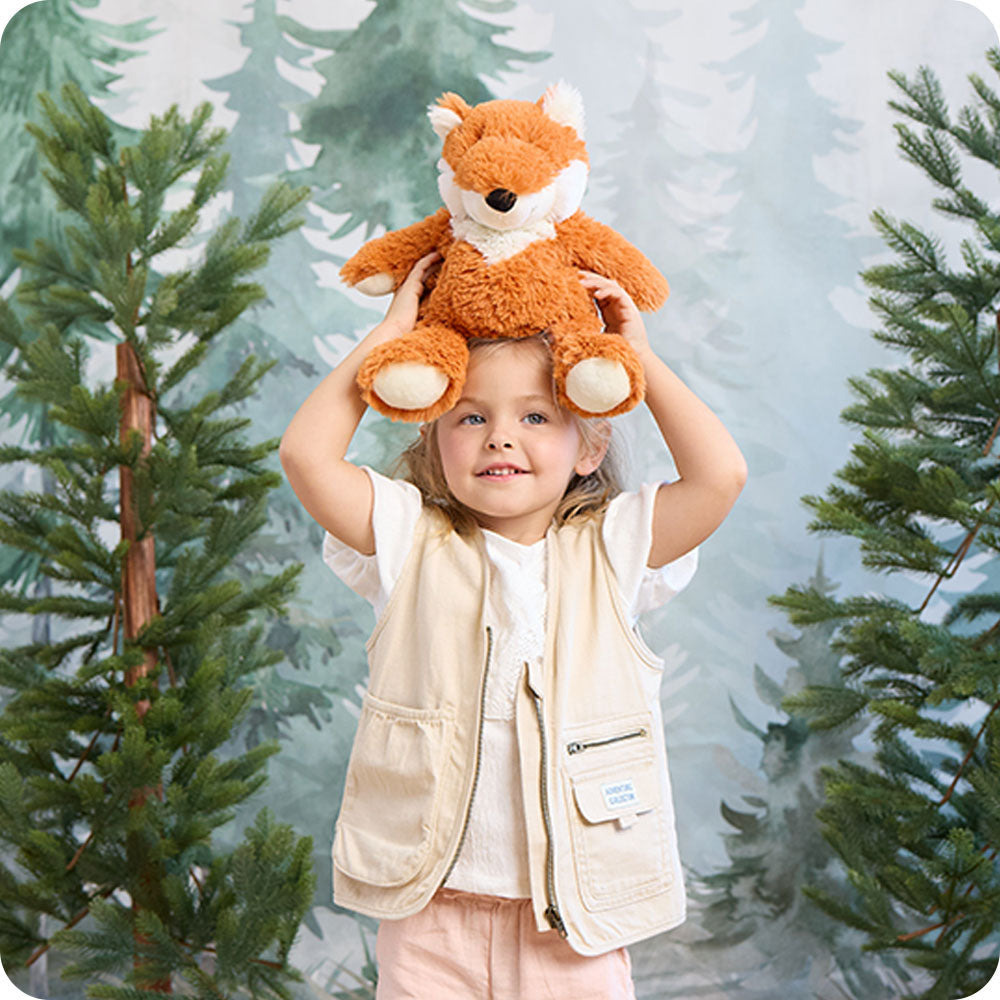 Image 94: woodland scene with girl holding a fox stuffed animal on her head