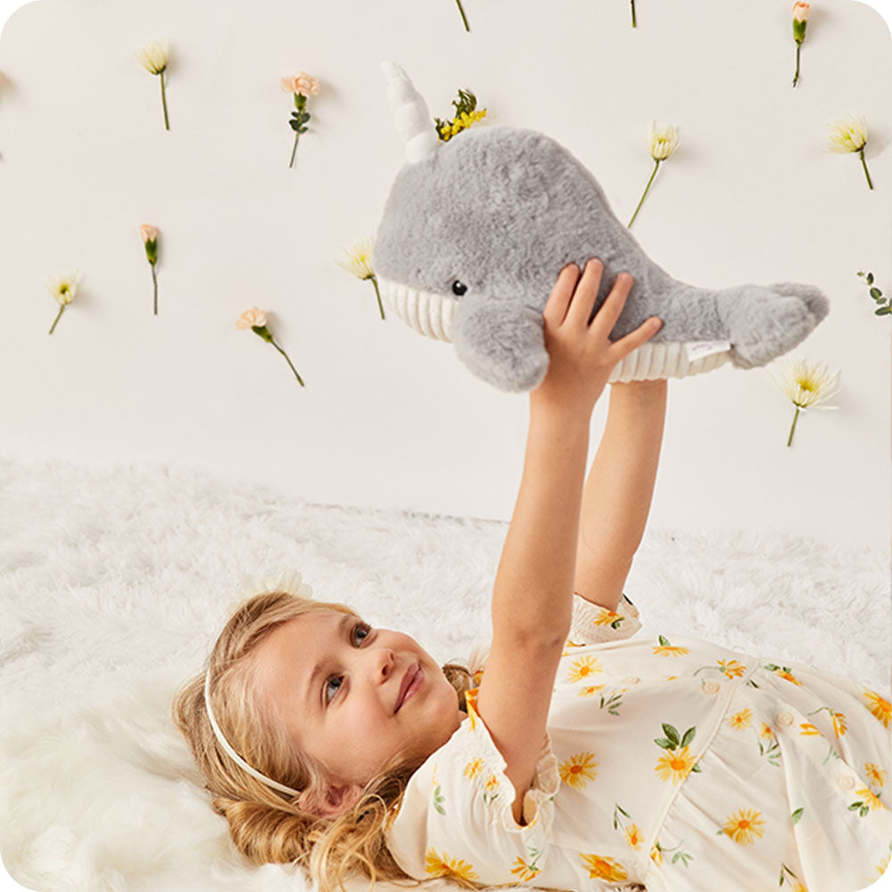 Image 102: girl holding narwhal stuffed animal
