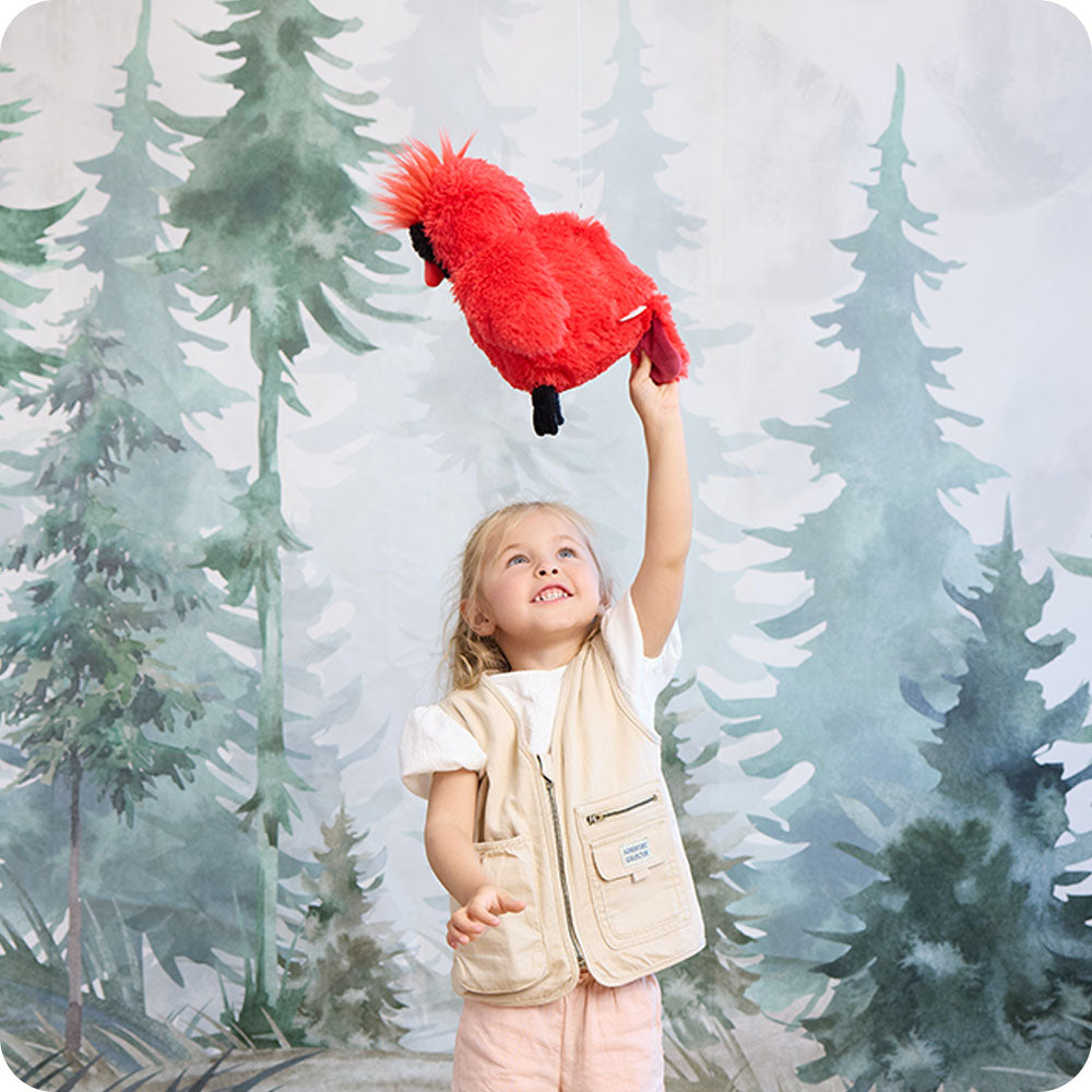 Image 103: girl playing with cardinal stuffed animal warmies
