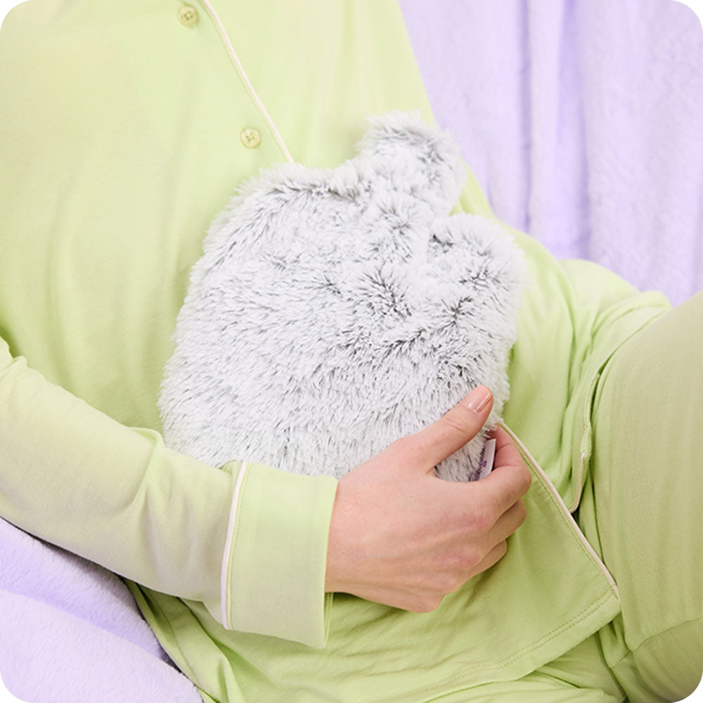 Image 103: woman holding Warmies Marshmallow Gray Microwavable Bottle