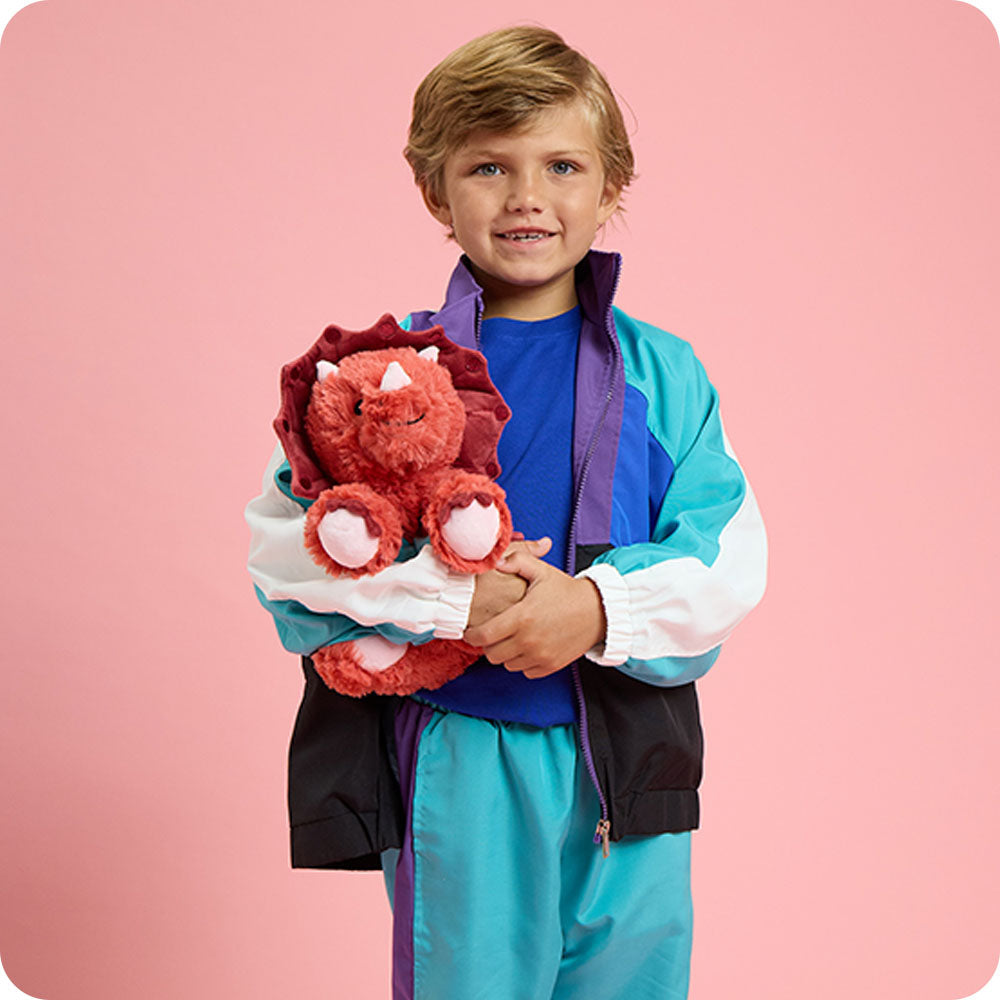 Image 103: boy holding red triceratops stuffed animals