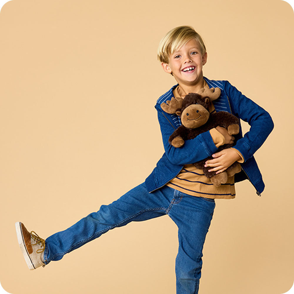Image 99: boy holding a moose stuffed animal