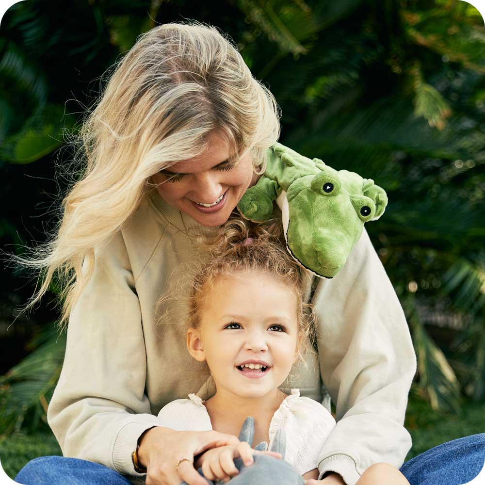 Image 100: Mother and Daughter play with a Cute Weighted Lavender Scented Alligator Stuffed Animal Heating Pad Warmies