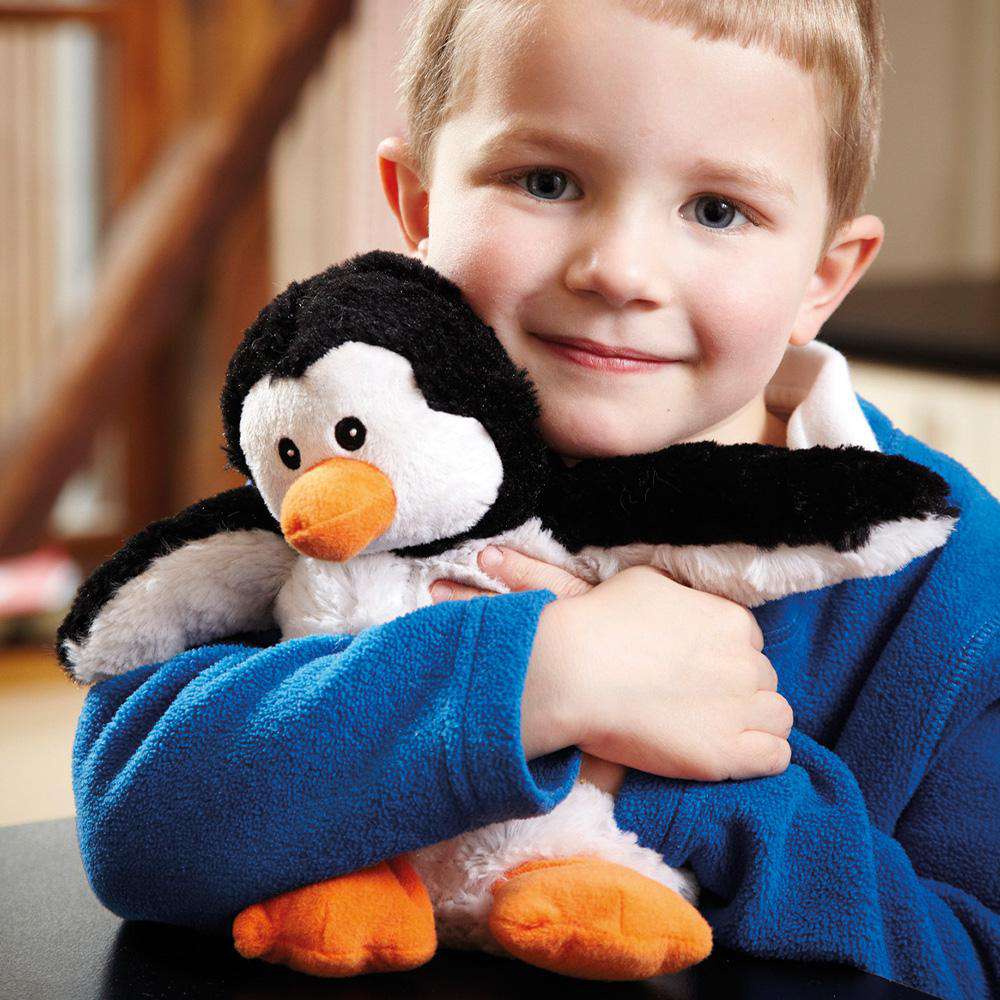 Image 96: Little boy hugging Soft Warm Weighted Penguin Plush Warmies